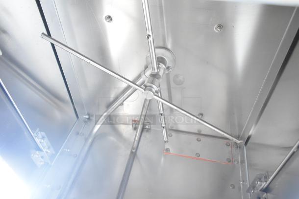 Inside view of a 2023 Jackson TempStar HH-E commercial dishwasher, showing stainless steel construction and spray arms.