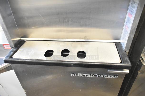 Electro Freeze 30T-RMT-137 soft serve machine, stainless steel, 2 flavors with twist, water-cooled, on commercial casters.