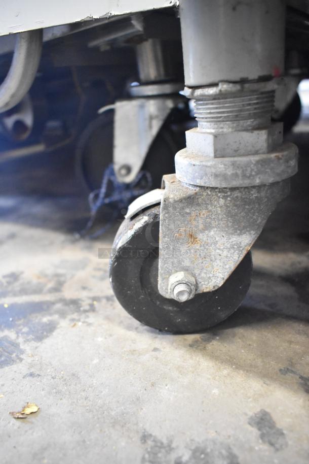 Electro Freeze 30T-RMT-137 ice cream machine caster, showing sturdy metal construction and signs of wear.