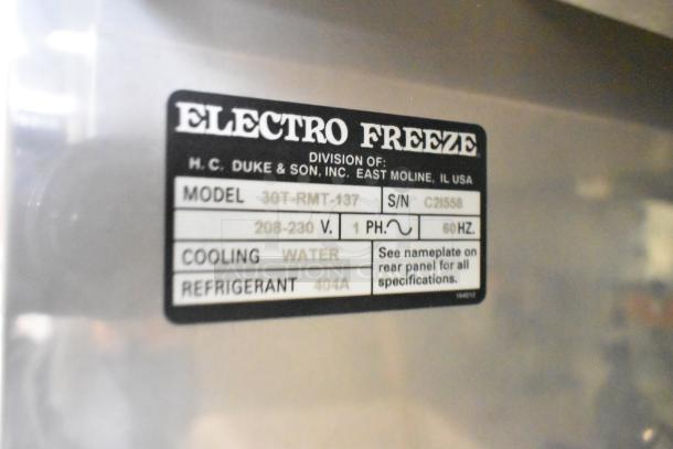 Electro Freeze 30T-RMT-137 soft serve machine nameplate showing model, serial number, voltage, and cooling specifications.