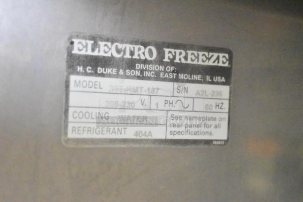 Label on Electro Freeze 30T-RMT-137 ice cream machine, shows model, voltage 208-230, phase 1, uses water cooling, refrigerant 404A.