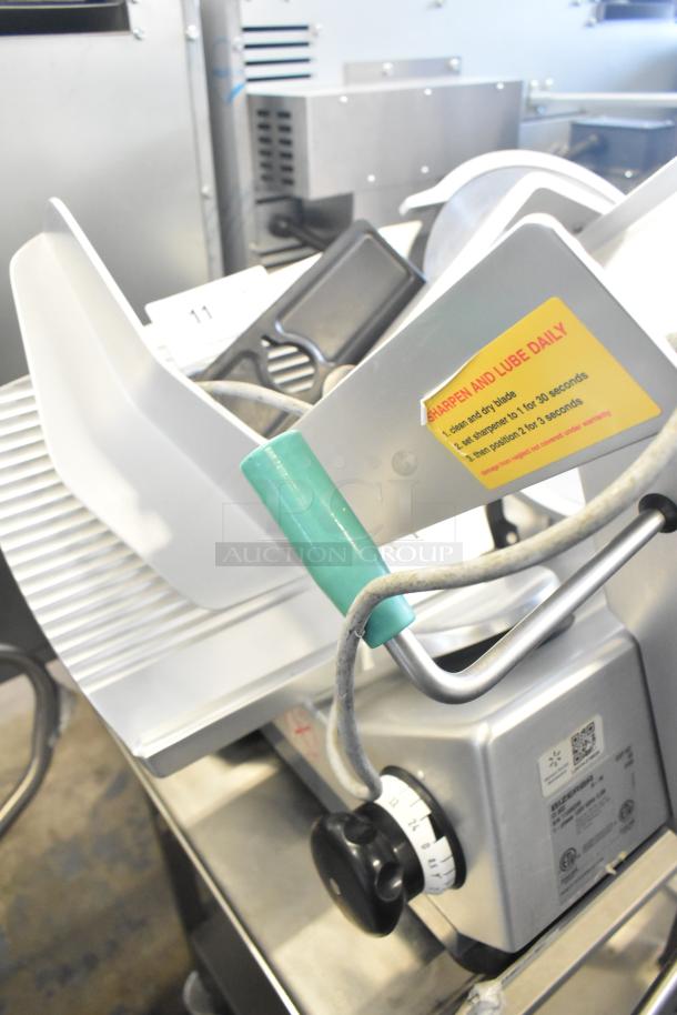 2018 Bizerba GSP HD meat slicer on equipment stand. Features blade, adjustment dials, and "Sharpen and Lube Daily" label.