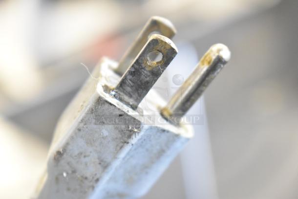 Close-up of a plug for the 2018 Bizerba GSP HD meat slicer, showing wear. 120 Volts, 1 Phase, commercial use.