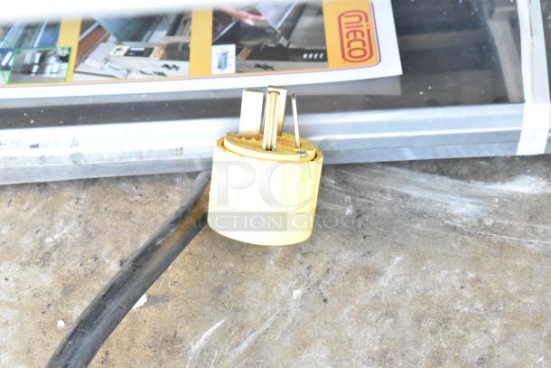 2021 Nieco JF93E electric conveyor charbroiled grill plug and manual on concrete floor, 208V, 3-phase power.