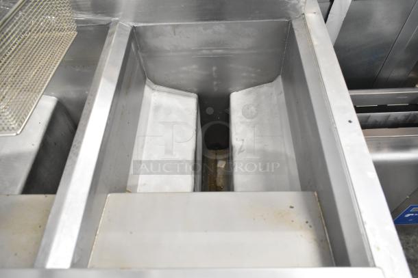 BRAND NEW 2021 Frymaster FPPH255CSE fryer interior, showing metal fry baskets and filtration system on commercial casters.