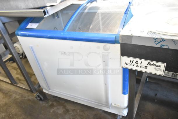 XS-208 Chest Freezer Merchandiser with commercial casters, 115 volts, 1 phase. Good condition with visible wear.