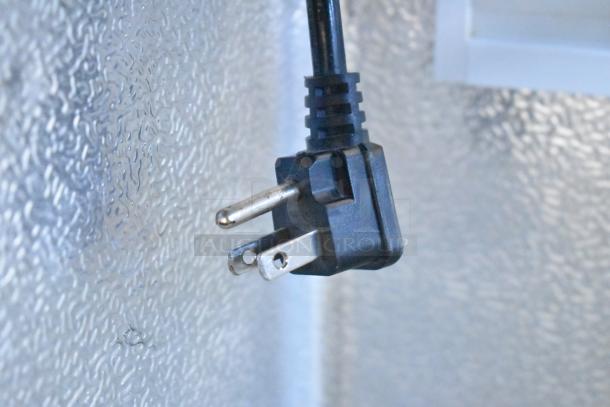 Plug of XS-208 Chest Freezer Merchandiser, 115 Volts, 1 Phase, in good condition. Close-up view.