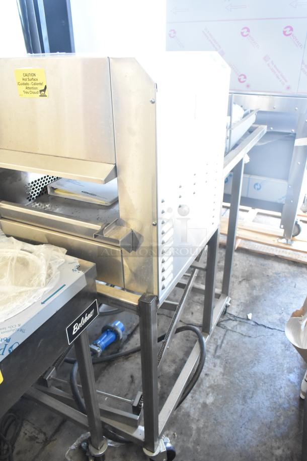 Belshaw Adamatic TG-50 stainless steel thermoglazing station on casters, 208V, 1 phase, caution label for hot surface.