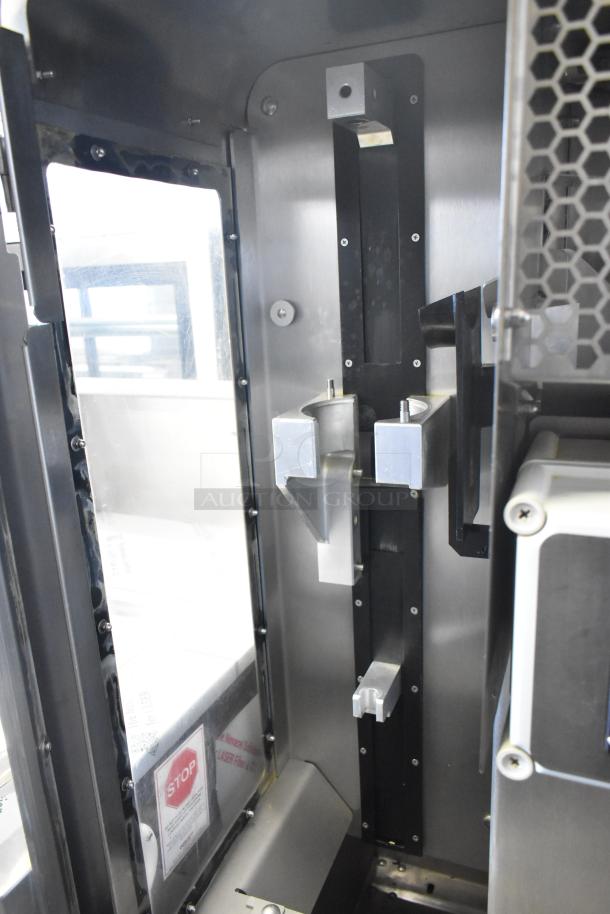 JBT 2ND-GEN-MFJ-HE citrus juicer interior view, showing metal components and casters. 120V, 1-phase.