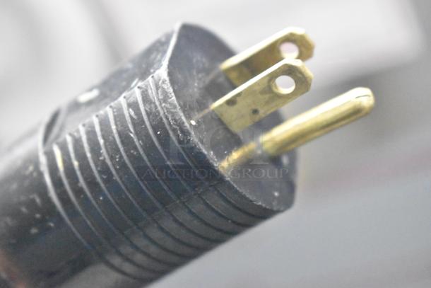 Close-up of a power plug for a JBT 2ND-GEN-MFJ-HE Citrus Juicer, showing metal prongs for 120 Volts, 1 Phase.