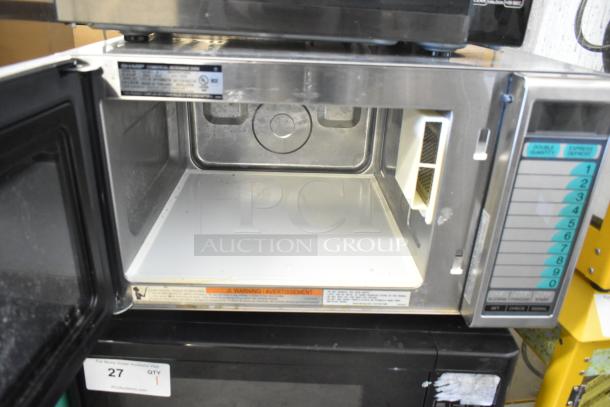 Sharp R-21LVF commercial countertop microwave, 120V, 1 phase, open door view, condition shows signs of use, controls visible.