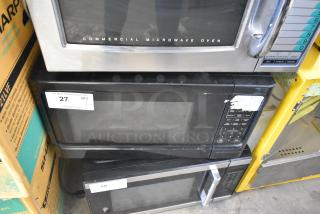 Mainstays P100N30AP-S3B1 microwave oven, black, 120 volts, 1 phase, visible surface wear, auction lot tag attached.