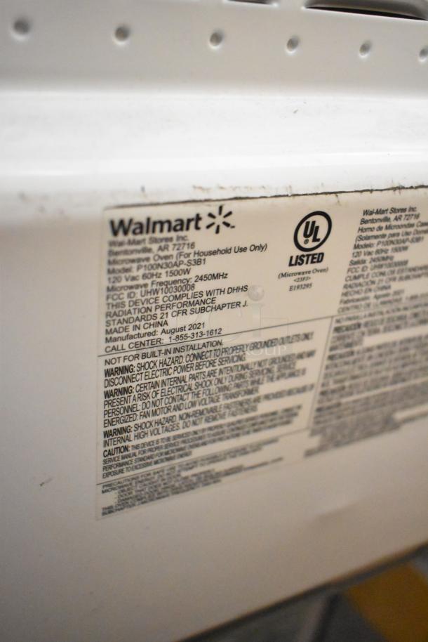 Mainstays P100N30AP-S3B1 countertop microwave, 120V, 1 phase, UL listed. Label with safety and compliance info visible.