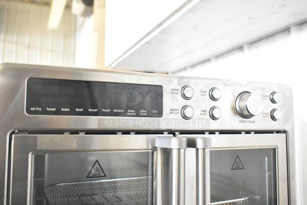 Chefman RJ50-FDAF-D25 digital French door air fryer oven with multiple function dials and buttons, stainless steel finish.