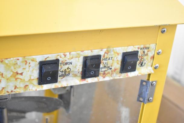 2019 OY-828 metal popcorn machine, yellow, with switch labels for turning, heating, and warming. 110 volts, 1 phase.