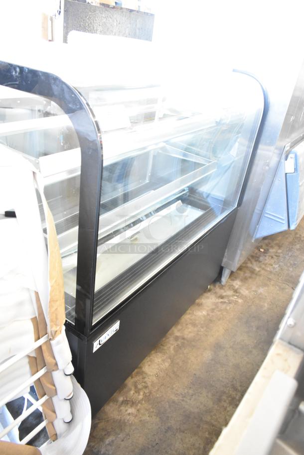 Brand new Avantco 193BC48HCB 48" curved glass black refrigerated bakery display case on commercial casters.
