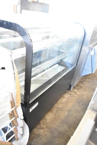 Brand new Avantco 193BC48HCB 48" curved glass black refrigerated bakery display case on commercial casters.