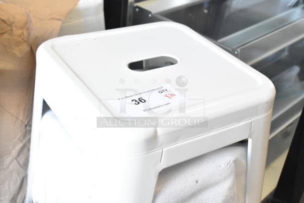 10 new white bar stools with minor scratches and dents, stackable design. Label reads "For More Great Auctions Visit Pciauctions.com."