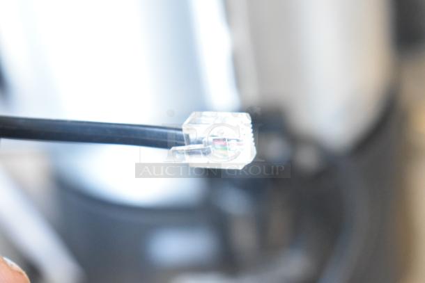 Close-up of a cable connector for a BRAND NEW Torrey SR-50/100 digital bench scale, Avantco model 177EG24N.