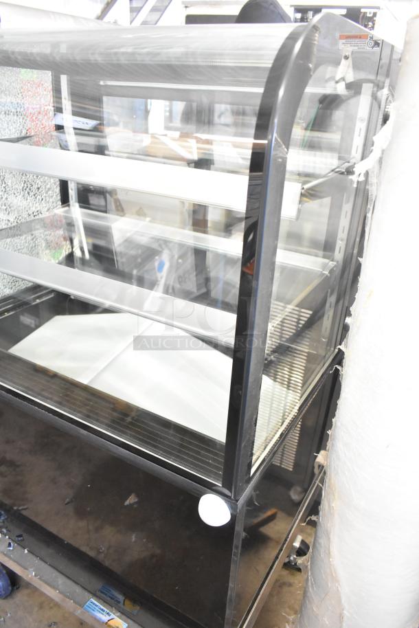 Avantco 193BCD36B 36" curved glass black dry bakery display case with visible broken glass. 110-120V, 1 phase.