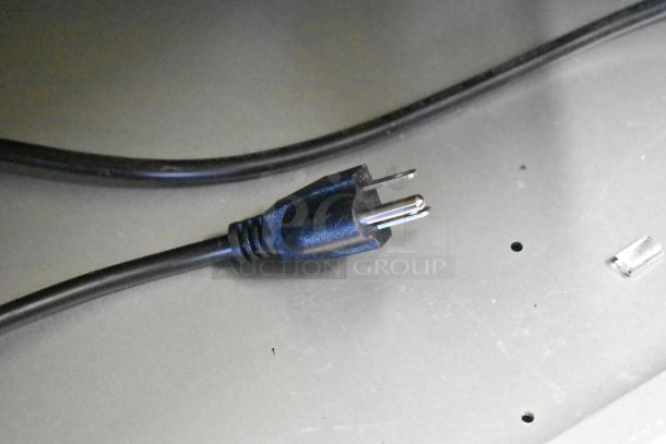 Power cord for Avantco 193BCD36B 36" bakery display case, 110-120 volts, 1 phase. Image shows plug and broken glass.
