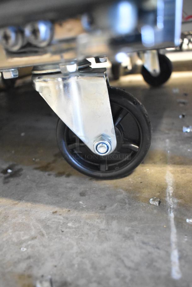 Commercial caster on Mainstreet 829PT48 refrigerated prep table, featuring sturdy metal construction, for auction.