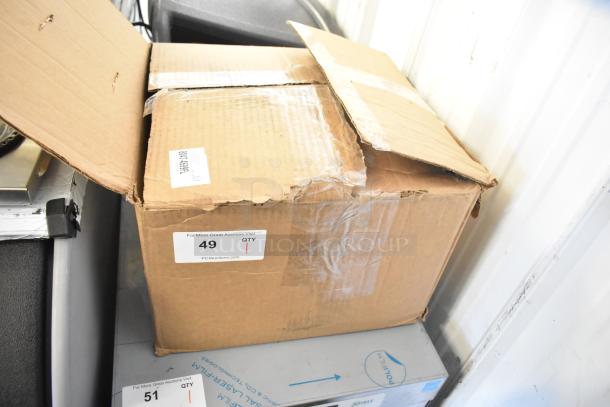 Cardboard box labeled for auction, open and slightly dented, likely containing Wells SS10ULTDCI Drop In Food Warmer.