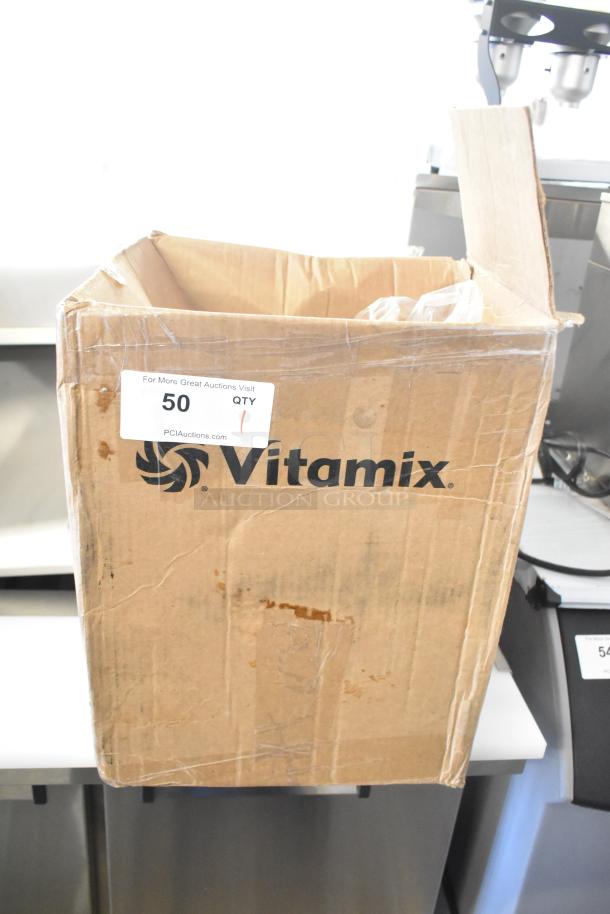 Box containing two new clear poly blender pitchers, Vitamix branding visible, labeled as scratch and dent.