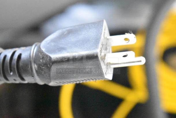 Close-up of a power plug for a Noble 495HTGW22 glass washer, showing prongs and black casing.