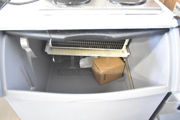 Brand new 2025 Ice-O-Matic ICEU220HA undercounter ice machine showing interior with bin, model ICEU220HA5.
