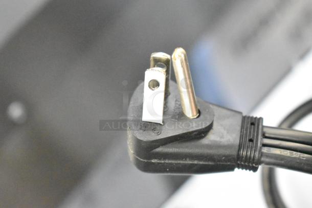 Close-up of a three-prong plug on a 2025 Ice-O-Matic ICEU220HA ice machine.