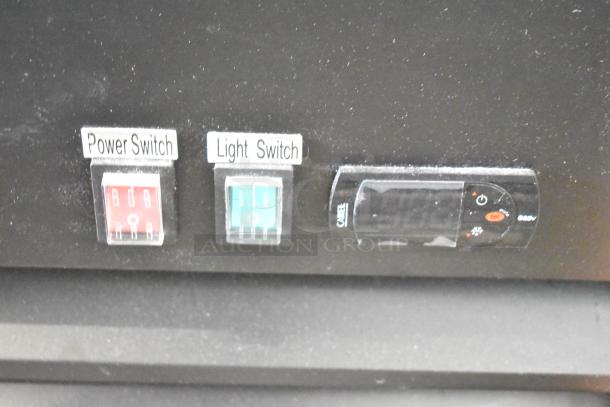 Avantco 178GDC15HCB merchandiser refrigerator controls, featuring red power switch, green light switch, and temperature control panel.