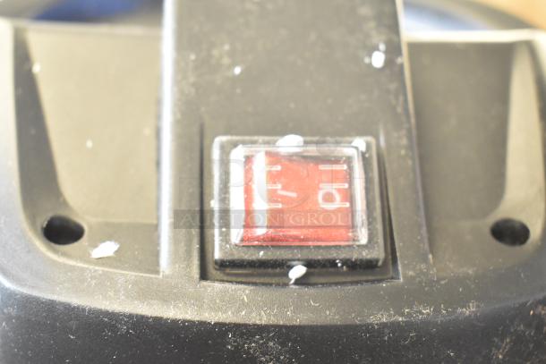 Alt text: Close-up of red switch on Lavex 944BJ162216G 16 Gallon Stainless Steel Wet/Dry Vacuum, showing scratches.