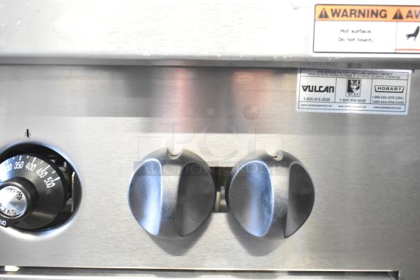 Vulcan 24S-4BN commercial range control panel. Features black knobs, temperature dial, and Vulcan branding label.