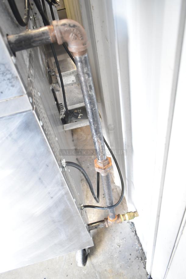 Southbend G Series commercial convection oven, gas connection detail, stainless steel, on casters.