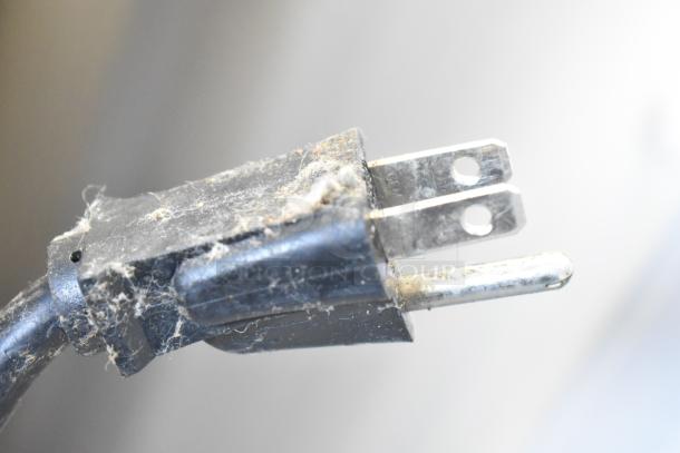 A dusty, close-up image of a three-prong electrical plug on a Southbend G Series convection oven.