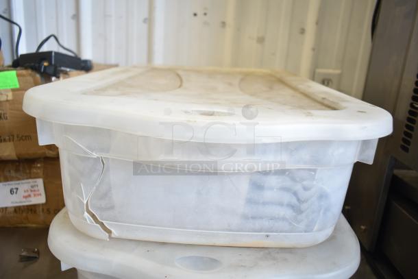 Two plastic bins containing various Taylor ice cream machine parts, including augers. Bins appear gently used. Auction lot offers double the winning bid in items.