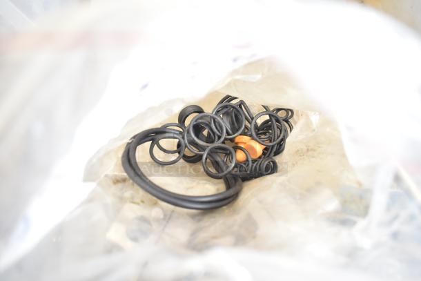 2 bins of various Taylor ice cream machine parts including augers, black O-rings, in a plastic bag.