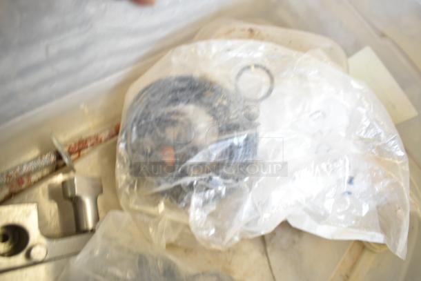 2 bins of various Taylor ice cream machine parts, including augers, assorted in clear bags. Ideal for repairs.