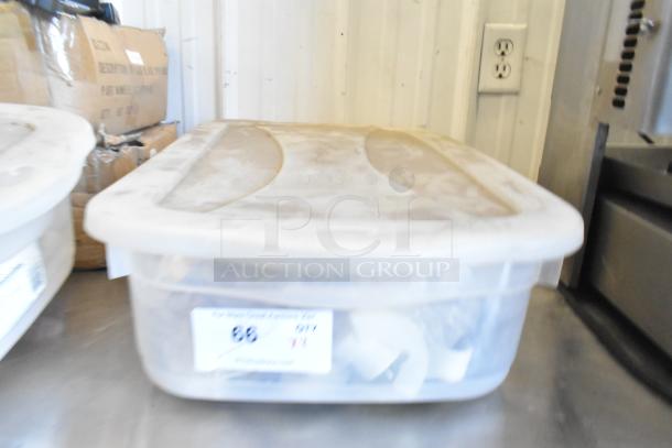 Clear plastic bin containing various Taylor ice cream machine parts, including augers. Label visible on the front.