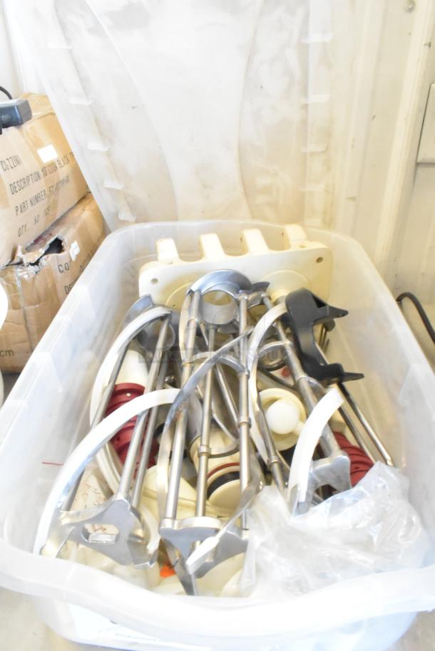 Two bins containing assorted Taylor ice cream machine parts, including metal augers, in used condition.