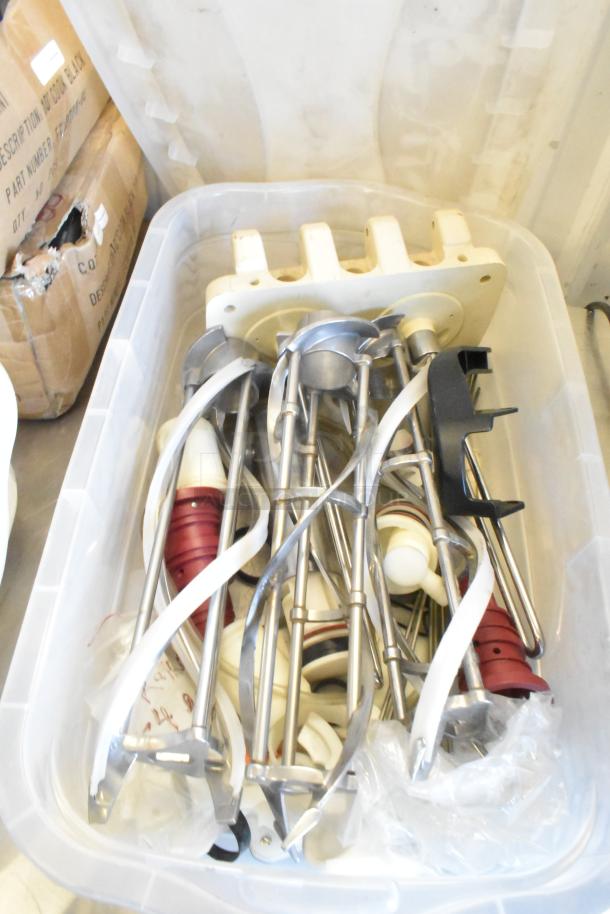 Bins of Taylor ice cream machine parts including augers, in good condition for auction.