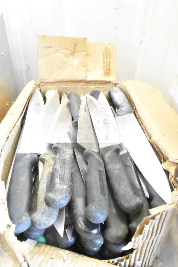 Box of 100 sharpened stainless steel knives with black handles, including chef knives, in fair condition.