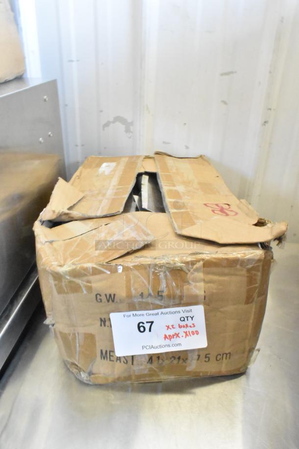 Box of 100 sharpened stainless steel knives, including chef knife, in opened, taped cardboard box. Auction label visible.