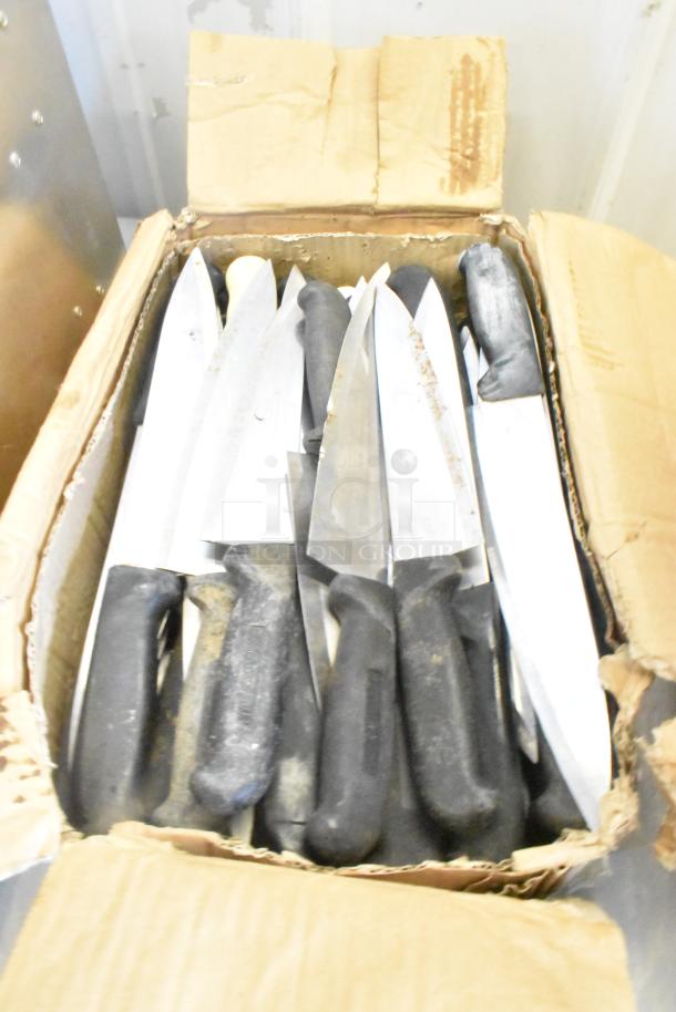A box of 100 sharpened stainless steel knives, including chef knives, with black handles, in used condition.