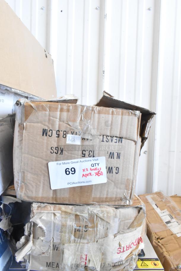 Boxes containing 60 sharpened stainless steel knives, including a chef knife. Auction tag indicates 2 boxes, approx. 60 items.