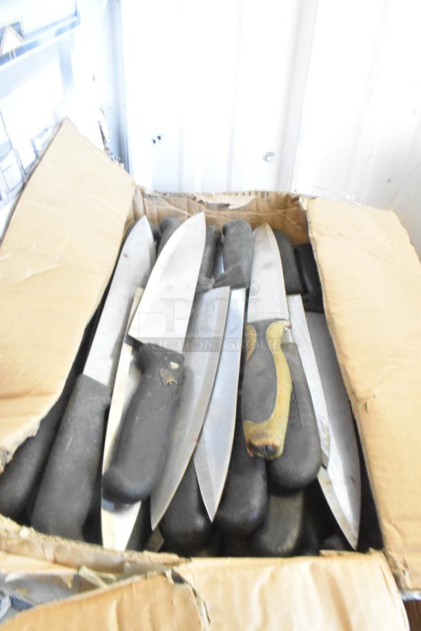 Box of 60 sharpened stainless steel knives, including chef knives, with black handles, in used condition.