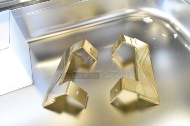 Golden handles for Choice Deluxe 407COH4 roll top chafer, brand new, on stainless steel surface.