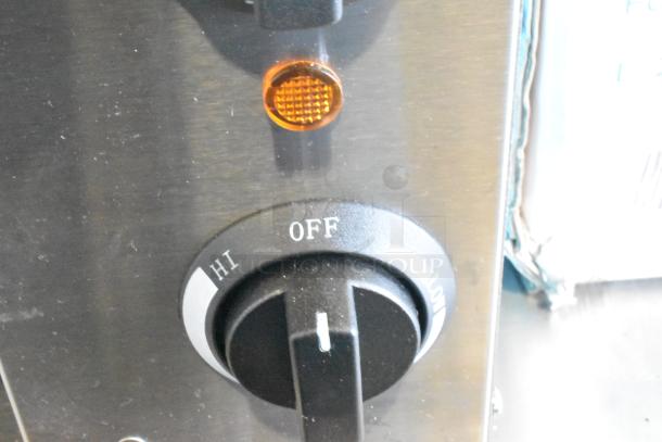 Close-up of Avantco 177CHSME32M cheese melter control with Hi, Off, Low settings and an indicator light on stainless steel.