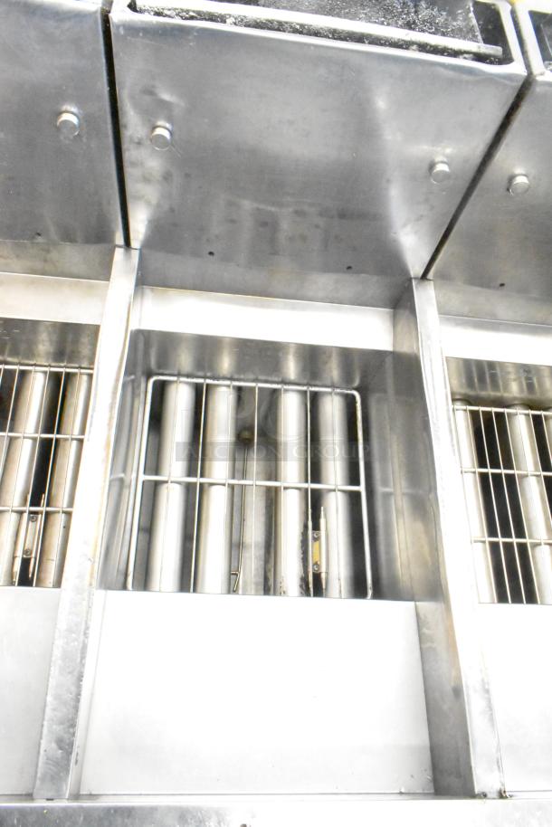 Pitco Frialator stainless steel 4-bay natural gas fryer on casters, 122,000 BTU, commercial use, shown in good condition.